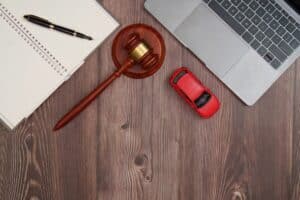 Legal tools with gavel, notebook, and toy car