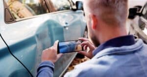 Insurance Investigator Captures Evidence Of Car Accident Aftermath On Smartphone.