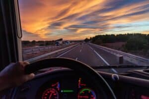 View from the driver's seat of a truck of a highway with vehicles in both directions.