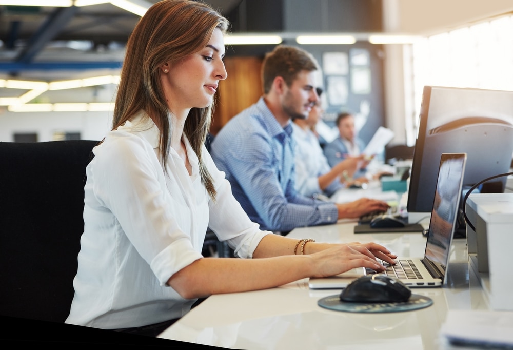 Business, woman and typing with laptop in office for research, data entry and insurance report.
