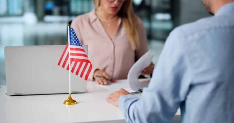 Immigration Lawyer Assists Client At US Embassy Visa Interview. Young Couple Applies For Green Card