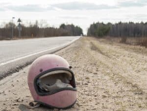 Motorcycle retro helmet lying by the road without glass after an accident.