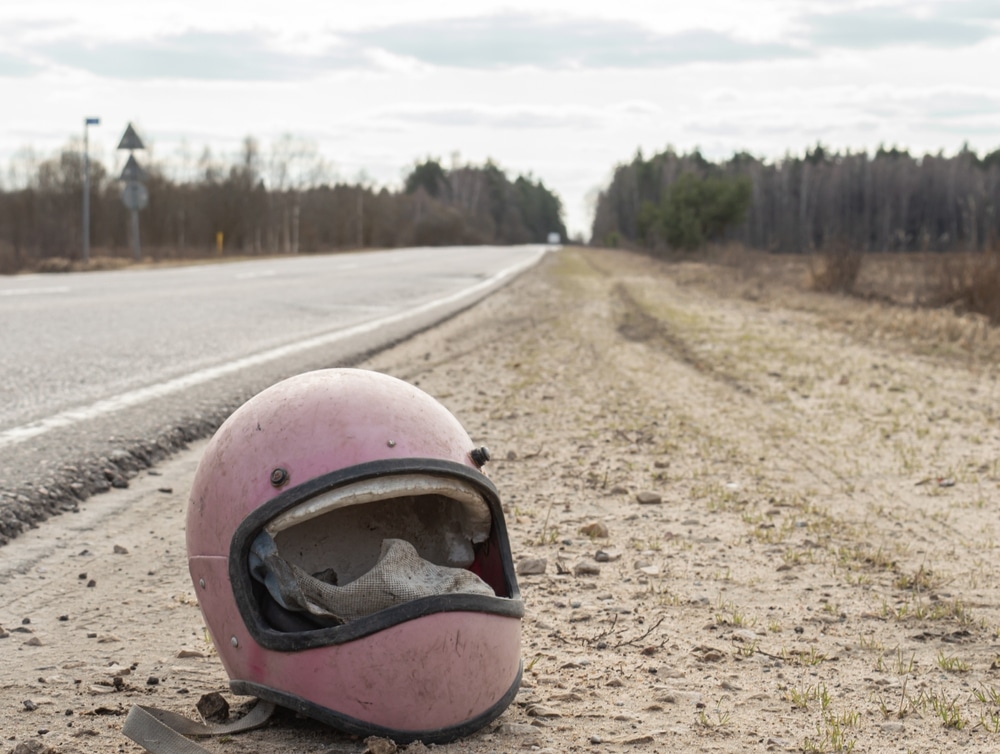 Motorcycle retro helmet lying by the road without glass after an accident.
