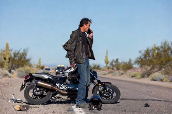 Motorcyclist consulting with a Phoenix motorcycle accident attorney after a crash.