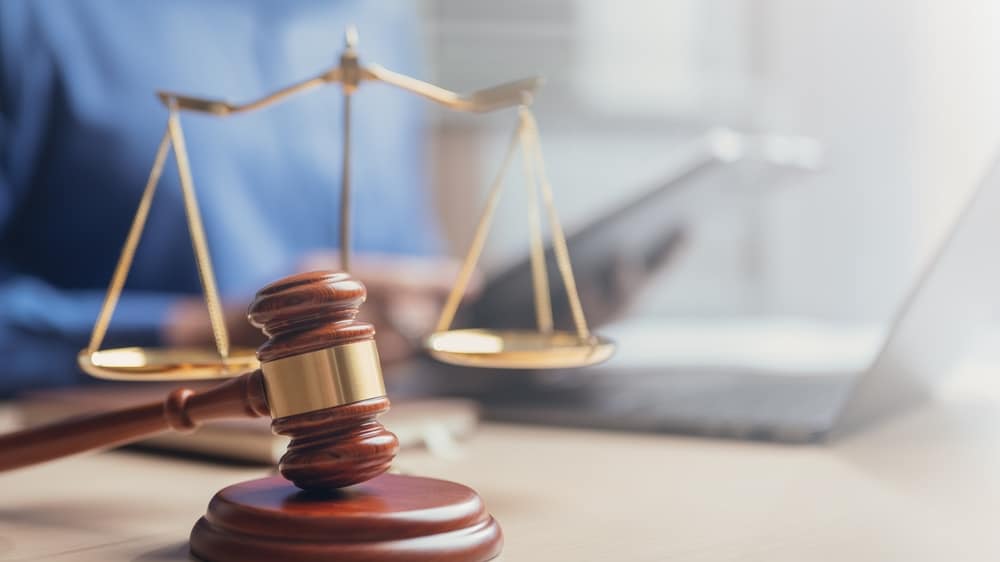 Judge gavel with white puzzle pieces to symbolize the question of whether you should file a claim or get a lawyer first.
