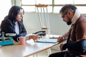 Injured man meeting with a lawyer to discuss a motorcycle accident claim
