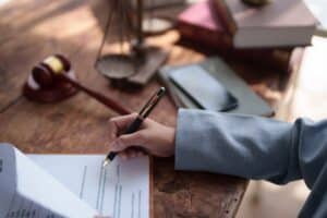 A Lawyer working on paperwork for a client, which is one way an accident attorney can help with a case.