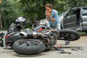 A motorcyclist dealing with an injury after a motorcycle accident involving a motorist