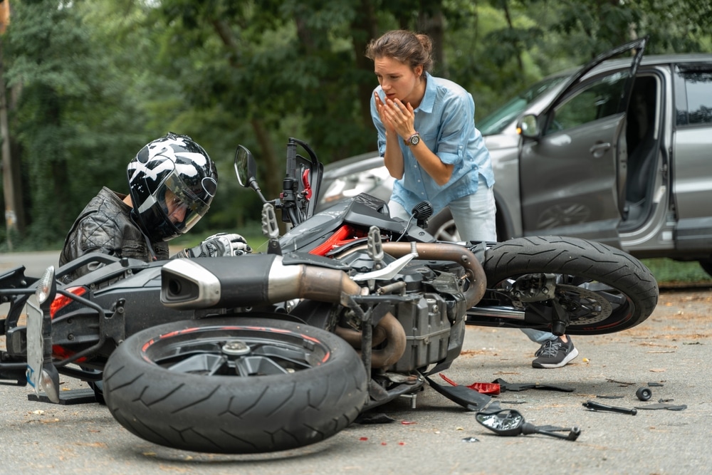 A motorcyclist dealing with an injury after a motorcycle accident involving a motorist